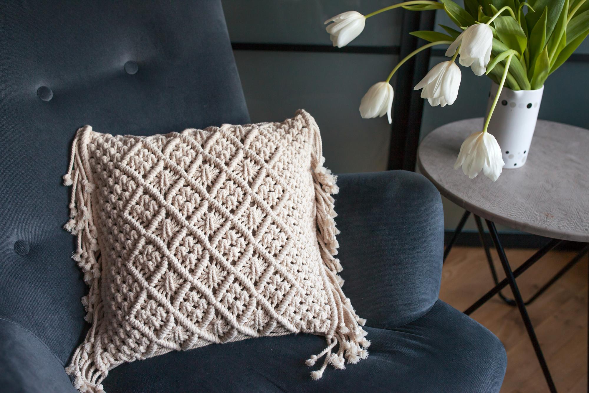 Embroidered cushion with geometric motif on a sofa